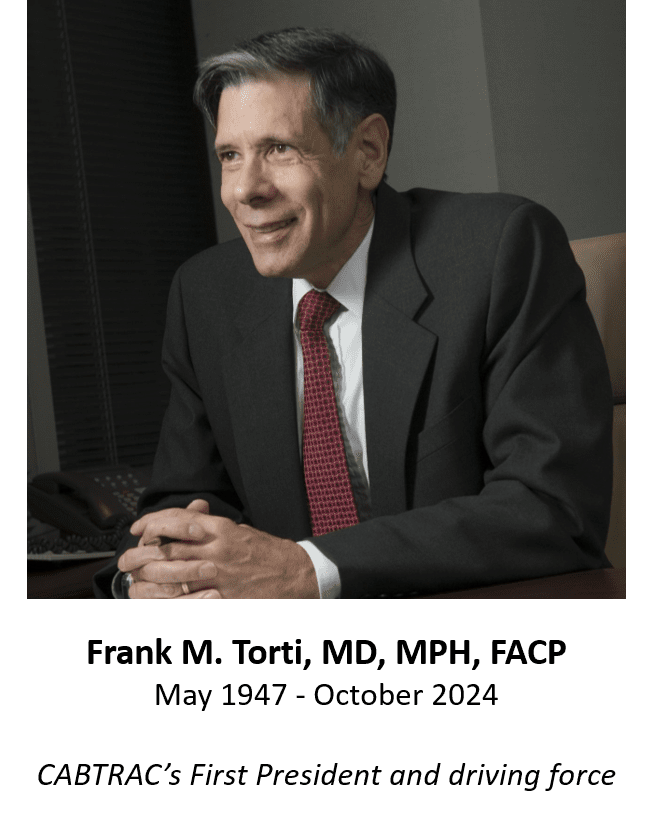 Man in suit smiling at desk